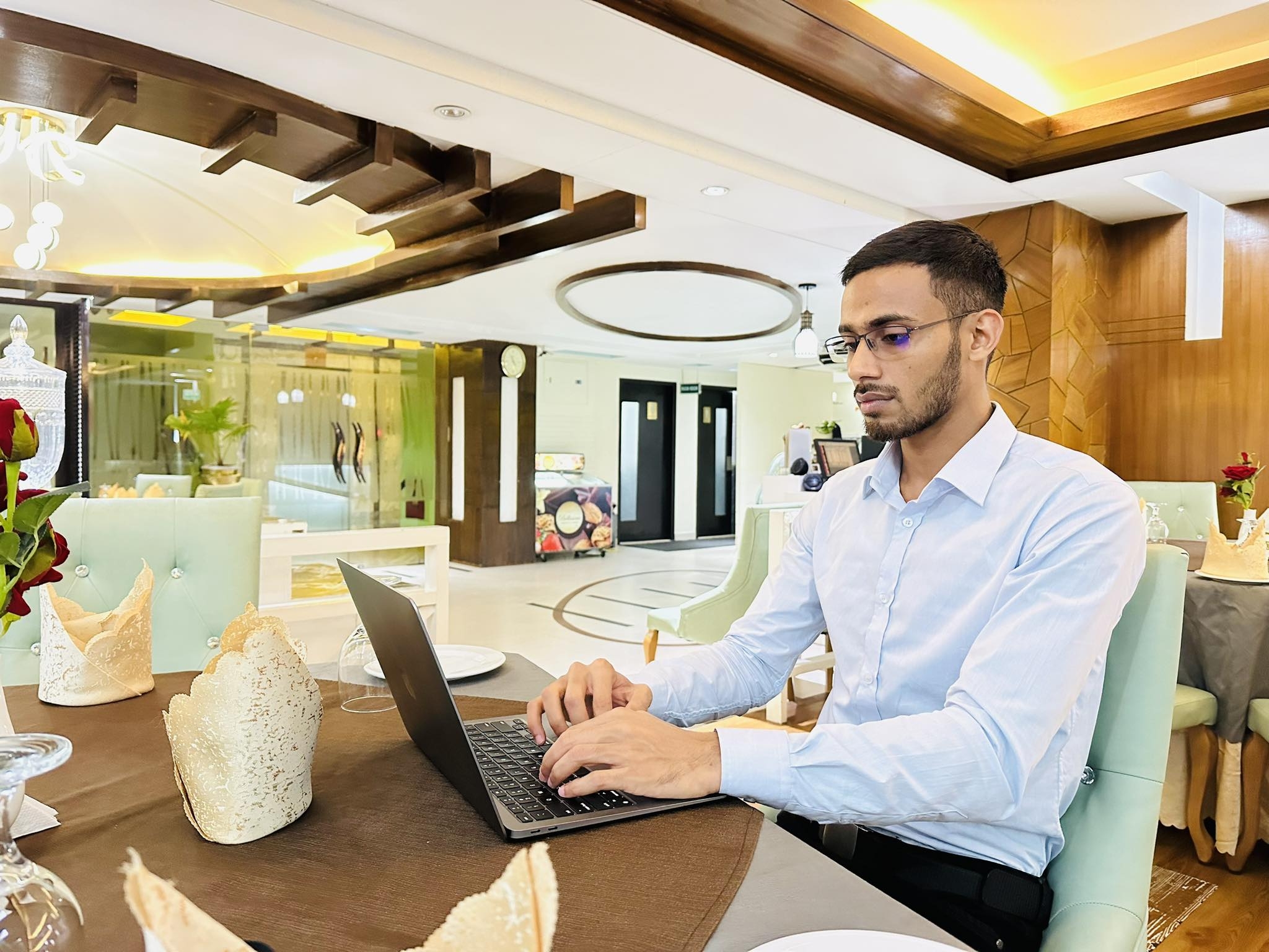 Minhaj Sadik working on a laptop